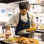 A chef preparing seafood.